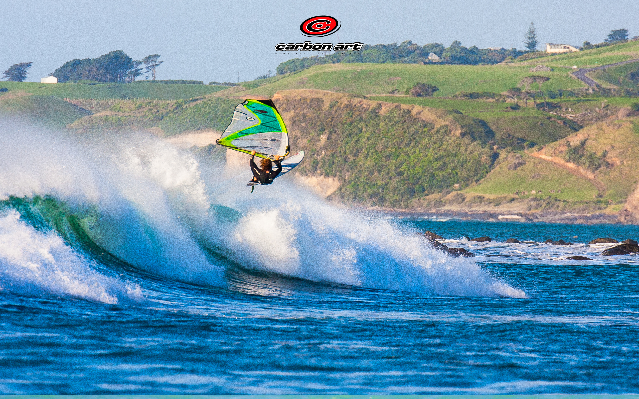 aerial windsurf jump with new zealand countryside background